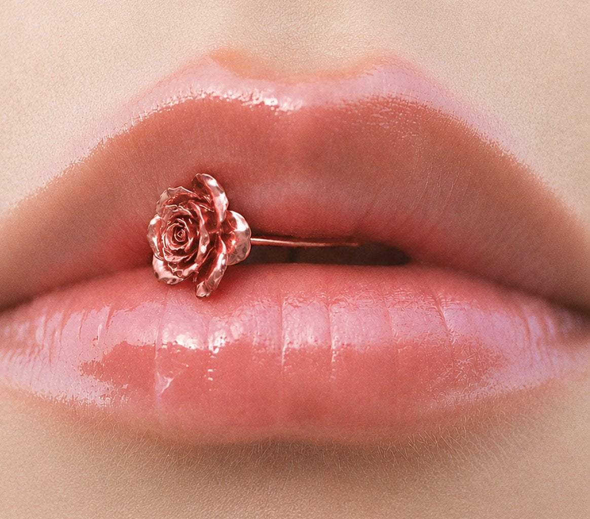 Glossy lips holding a rose-gold rose