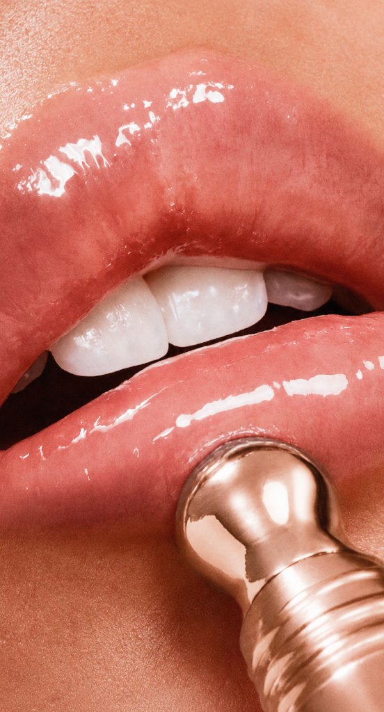 Applying Rosé Hour with the rose-gold applicator to glossy lips